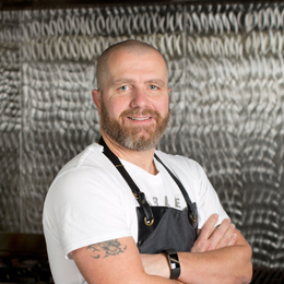 Adi Bernhard standing in kitchen